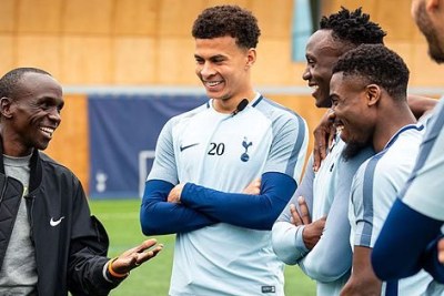 London Marathon champion Eluid Kipchoge (left) interacts with Tottenham Hotspur players during a visit to the football club.