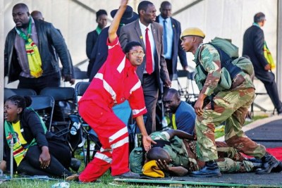 Medics attend to people injured in an explosion during a Zanu-PF rally in Bulawayo.