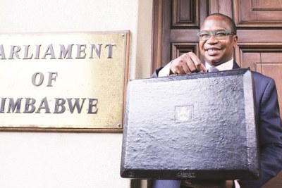 Finance and Economic Development Minister Professor Mthuli Ncube poses for a photograph with his briefcase before presenting his 2019 National Budget proposals in Parliament.