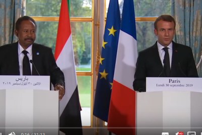 Sudan's Prime Minister Abdallah Hamdok, left, and French President Emmanuel Macron hold a press conference on September 30, 2019.