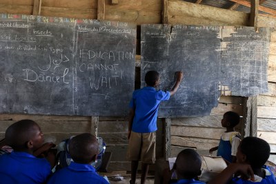 A student writes on a blackboard at the Souza Gare school in the Littoral region, Cameroon. The school hosts displaced children who have fled the violence in the North-West and South-West regions (file photo).