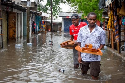 Floods are destroying livelihoods across the African continent. Here, artisans wade through knee-high flood water in Dar es Salaam, Tanzania (file image).