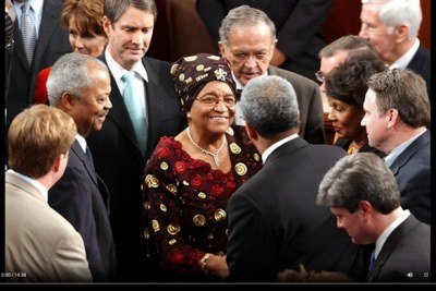 Liberian President Ellen Johnson Sirleaf on the floor of the U.S. House after addressing a Joint Meeting of Congress. Among those members greeting her are (left) Rep. Donald Payne (D-New Jersey) and (rear) Senate Majority Leader Bill First (R-Tennessee) and Sen. Ted Stevens, R-Alaska.